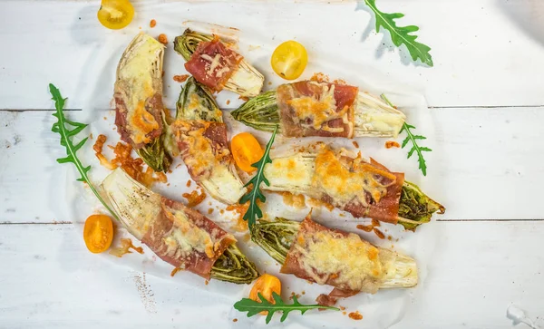 Roasted witlof with prosciutto — Stock Photo, Image