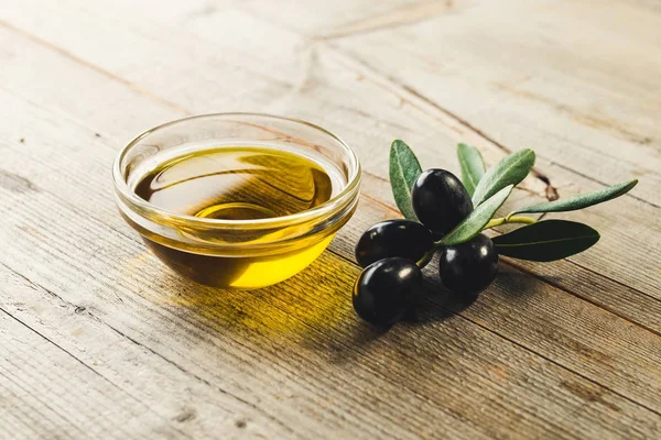 Олія з оливками на дерев'яному столі — стокове фото