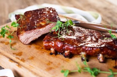 close up view of smoked Barbecue Pork Spare Ribs on wooden board clipart