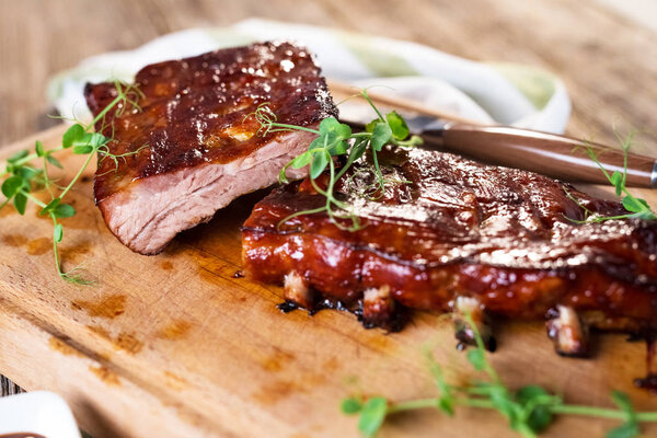 close up view of smoked Barbecue Pork Spare Ribs on wooden board