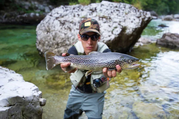 Close view of brown trout in fisherman hands