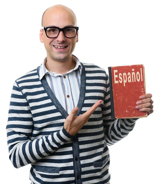 Gutaussehender Kerl mit einem Lehrbuch. Spanisch lernen — Stockfoto