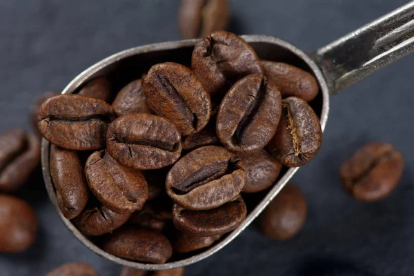 Close up of coffee beans in a spoon — Stock Photo, Image