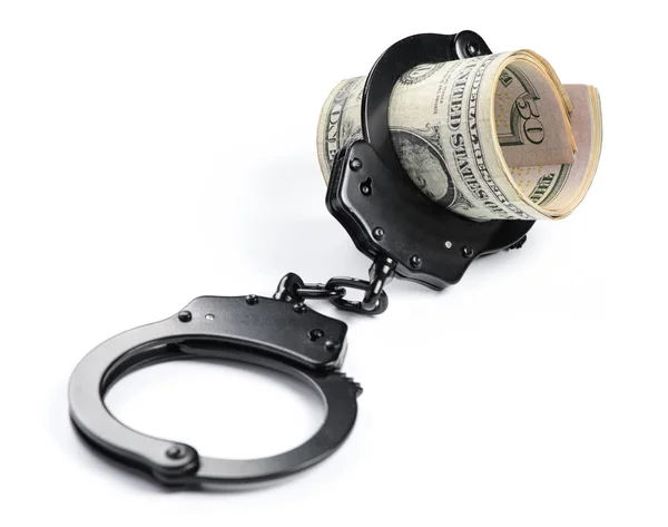 Деньги и наручники изолированы — стоковое фото
