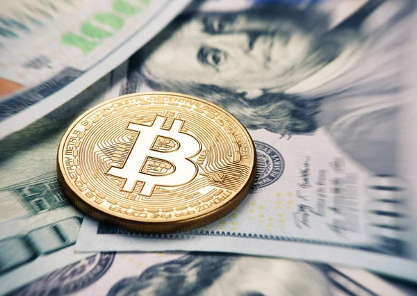 Bitcoin coin on a us dollar currency — Stock Photo, Image