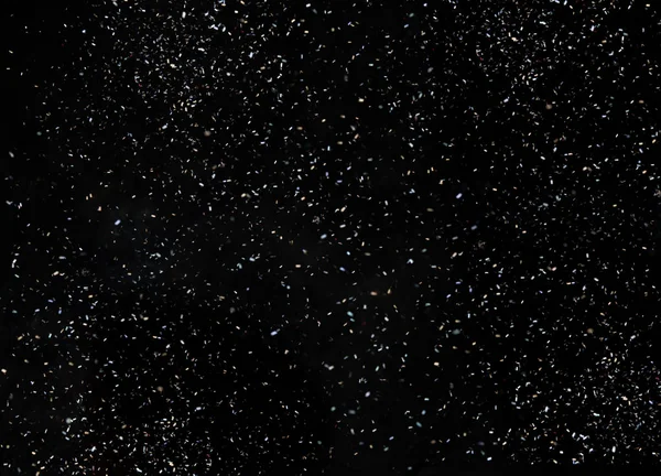 Confetes isolados sobre fundo preto — Fotografia de Stock