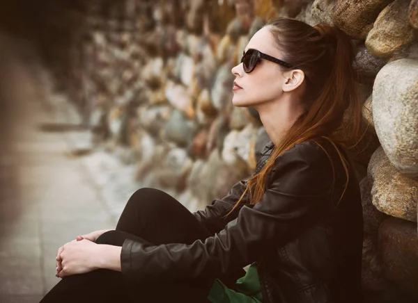 Pretty sad girl sits on street. — Stock Photo, Image