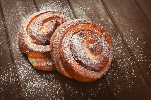 Sweet buns on a wooden background — Stock Photo, Image