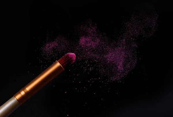 Makeup brush with pink powder explosion