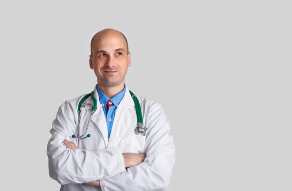 Smiling handsome doctor looking up. Isolated — Stock Photo, Image