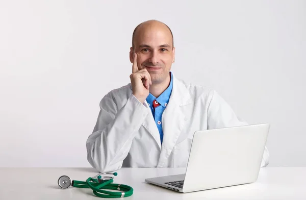 Dizüstü bilgisayar ile gülümseyen yakışıklı doktor — Stok fotoğraf