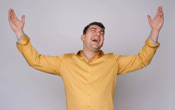 Portrait of excited man with raised hands — Stock Photo, Image