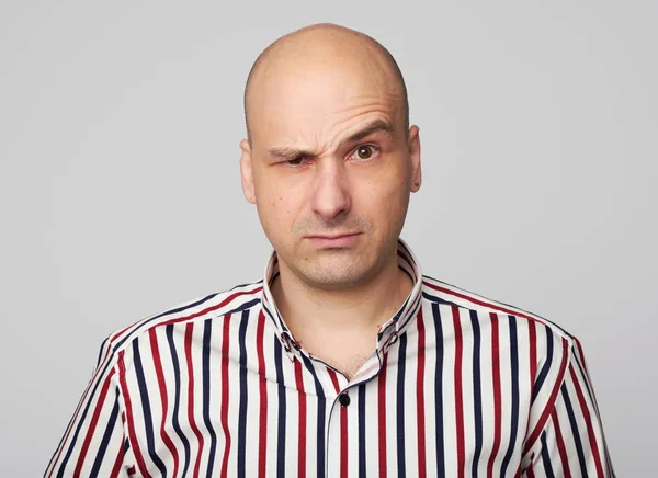 Serious bald man raised eyebrow. Isolated — Stock Photo, Image