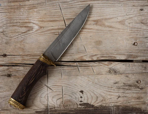 Hunting knife on a wooden background — Stock Photo, Image