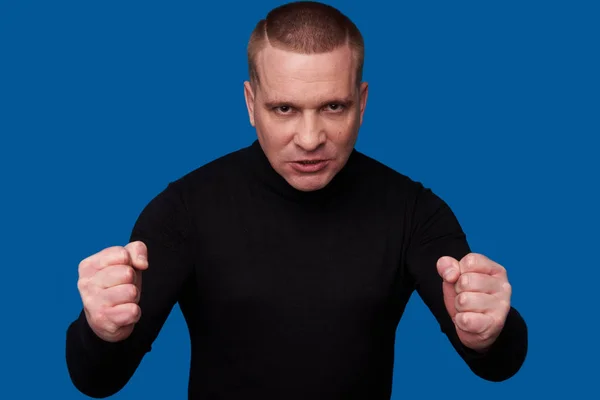 Angry man wearing black turtleneck — Stock Photo, Image