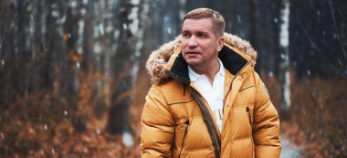 Kış parkında orta yaşlı beyaz bir adam.