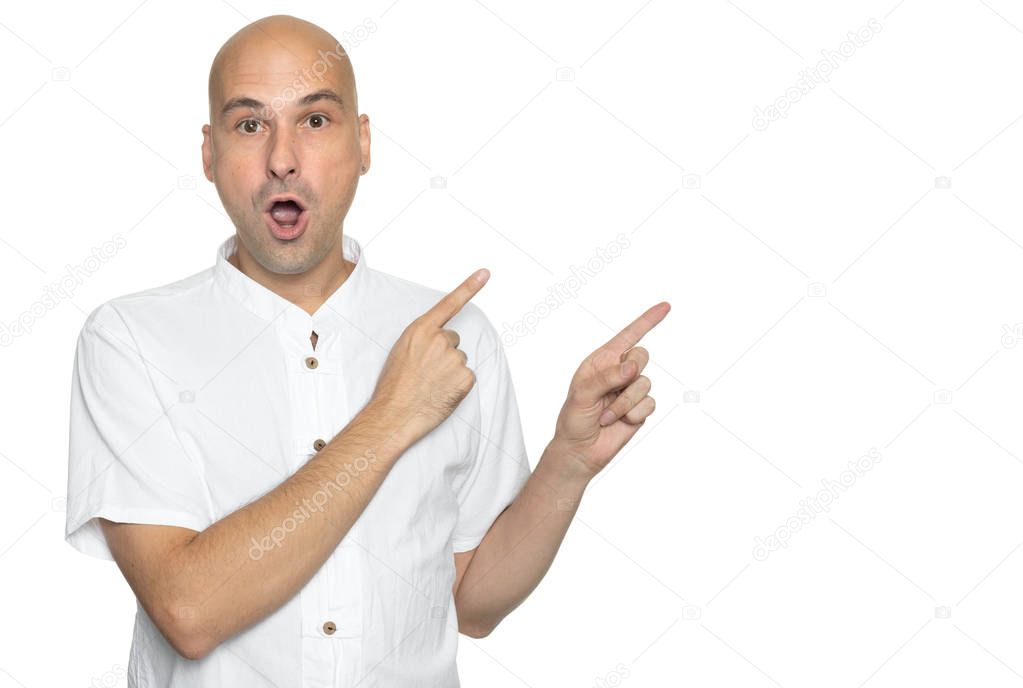 bald man in casual white shirt is pointing fingers. Isolated