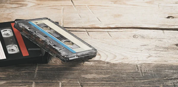 Two old audio tapes on wooden background — Stock Photo, Image