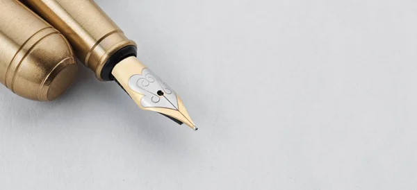 Golden Fountain Pen on a white background — Stock Photo, Image