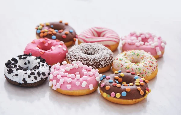 Mix of multicolored sweet doughnuts with sprinkles — Stock Photo, Image