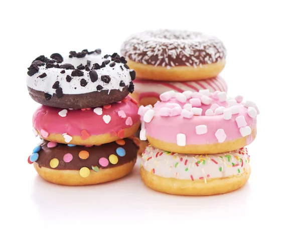 Stack of glazed doughnuts with sprinkles on white — Stock Photo, Image