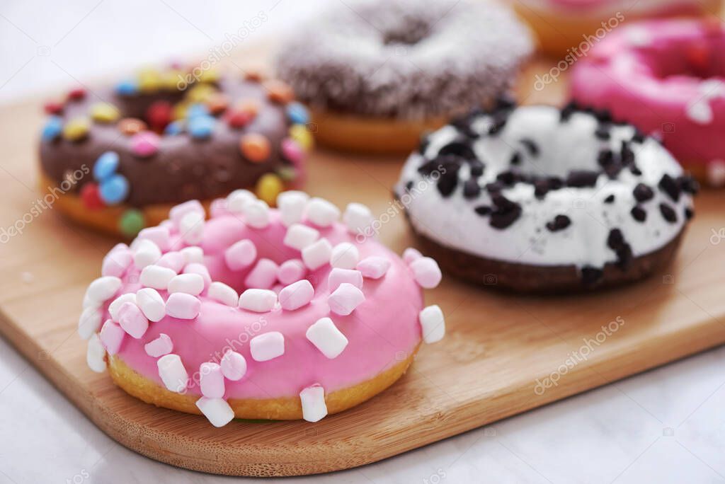mix of multicolored sweet doughnuts with sprinkles