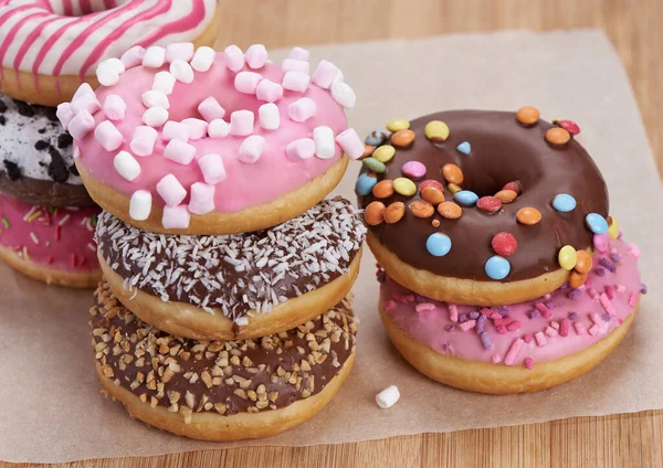 Heap of colorful doughnuts on a table — Stock Photo, Image