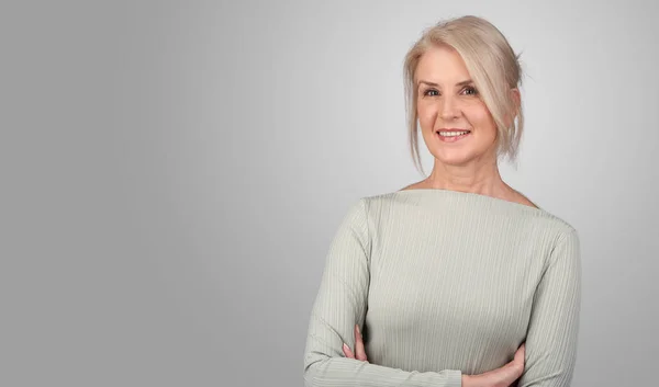 Senior blonde vrouw is glimlachen geïsoleerd — Stockfoto