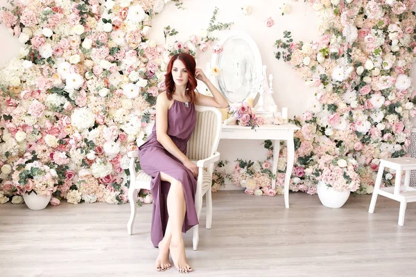 Young girl on a background of spring flowers — Stock Photo, Image