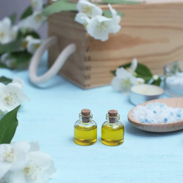 Aromatic oils, sea salt, candles and jasmine flowers. Spa ingred — Stock Photo, Image