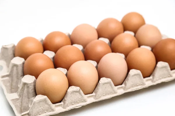 Fresh chicken eggs in paper tray isolated on white background — Stock Photo, Image