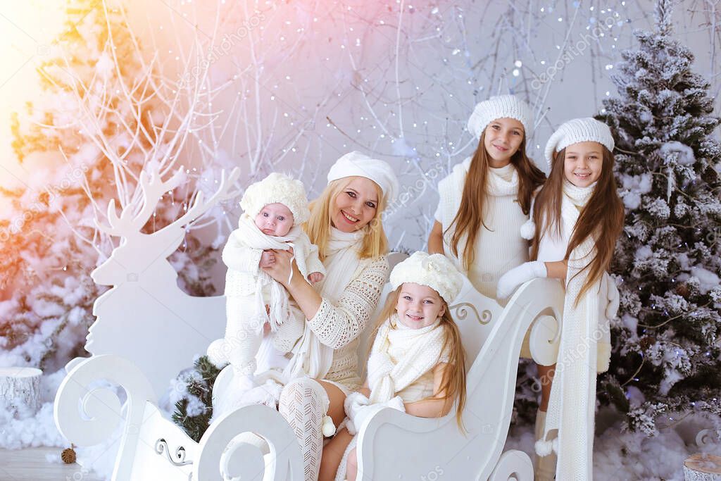 Happy kids and mom  wooden sleigh over christmas background
