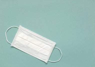 Yeşil arka planda tıbbi maske. Sağlık ve tıbbi konsept. Salgın virüsü COVID-19