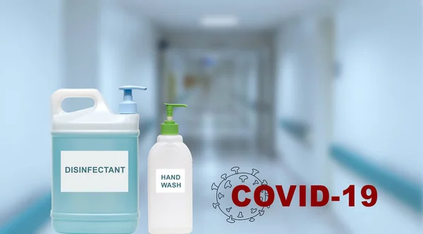 Disinfectant containers on blurred background of hospital hall. Pandemic virus COVID-19