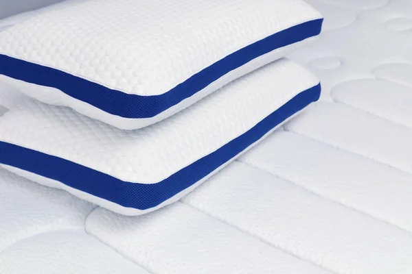 Orthopedic pillow on the quilted mattress. Comfortable bed for sleep and rest
