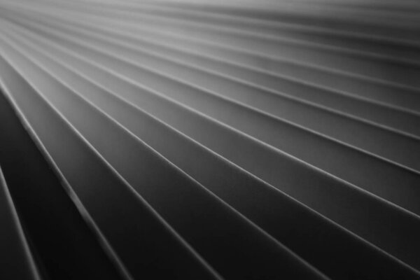 Paper folded zigzag. Textured monochrome background for design.