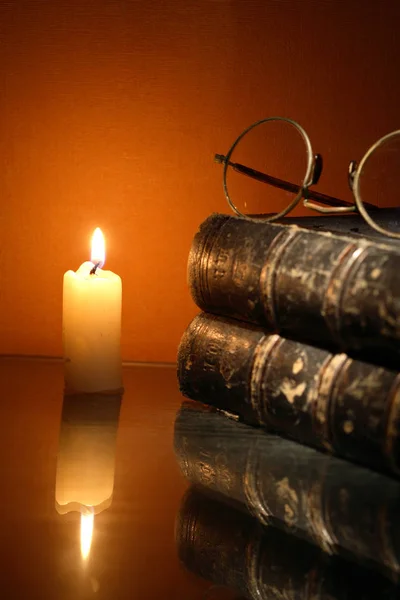 Lighting Candle Near Book — Stock Photo, Image