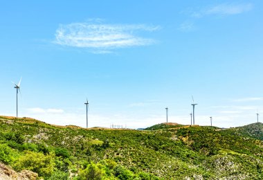 Wind power plant on a hill, sunny day. Greece
