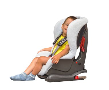 A three year old boy is sitting in a car seat. Isolated on white.