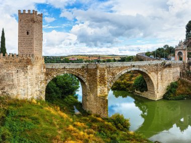 Toledo, Spain - June 6, 2018, The Puente de Alcantara is a Roman arch bridge in Toledo, Spain, spanning the Tagus River.