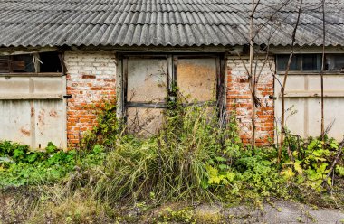 Ruined building old gate. .Abandoned collective farm. Russia, Tula region.