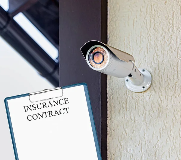 Security surveillance camera in private house. Insurance contract.