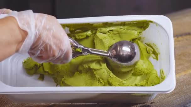 Green pistachios ice cream balls scooped by spoon — Stock Video