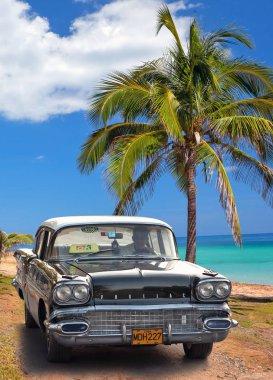 VARADERO, CUBA - MAY, 22, 2013: Black american classic car on th clipart