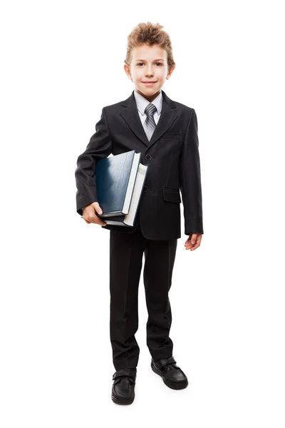 Χαμογελαστό παιδί αγόρι στο επαγγελματικό κοστούμι κρατώντας βιβλία — Φωτογραφία Αρχείου