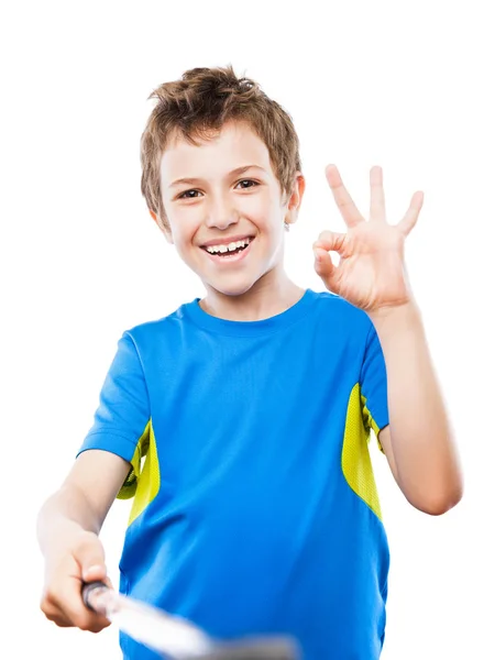 Handsome smiling child boy holding mobile phone or smartphone selfie stick taking photo — Stock Photo, Image