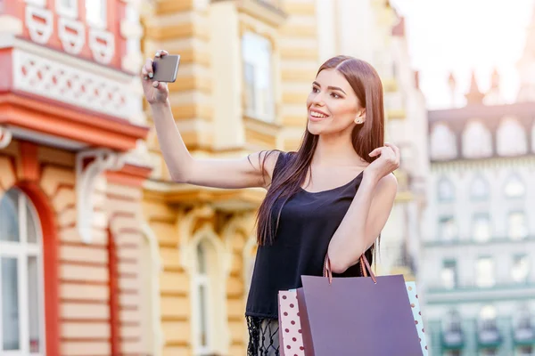 Glad ung kvinna med shoppingväskor — Stockfoto