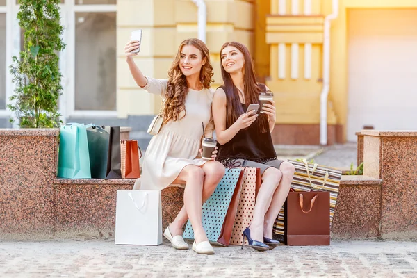 Gelukkig jonge vrouwen met shopping tassen — Stockfoto