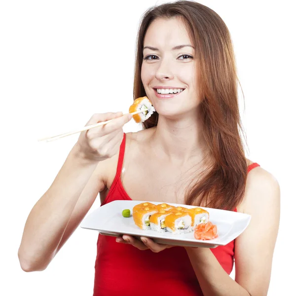 Schöne brünette Frau isst Sushi — Stockfoto