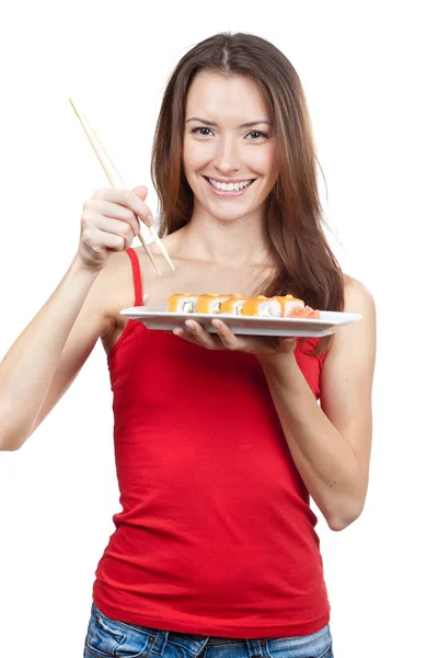 Belle femme brune mangeant des sushis — Photo